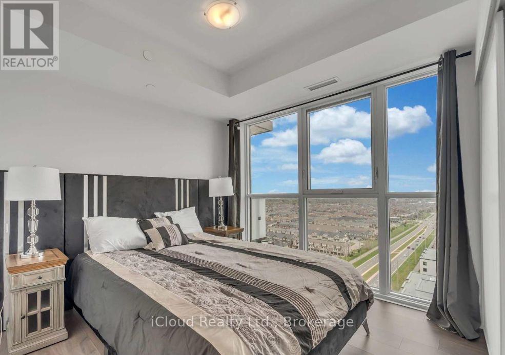 A bedroom with a large bed and a view of the city.