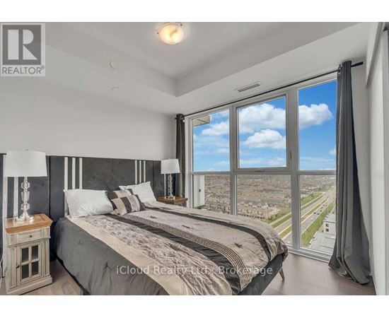 A bedroom with a large bed and a view of the city.