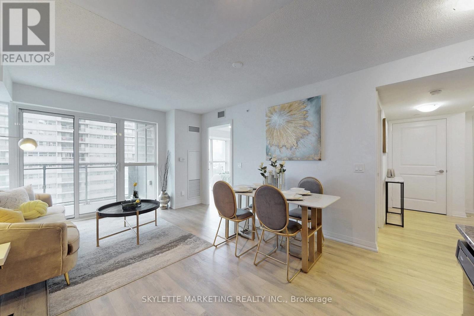 A living room with a dining table and chairs.