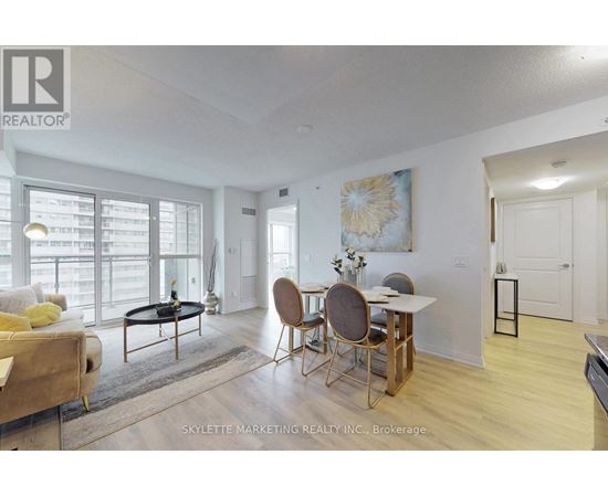 A living room with a dining table and chairs.