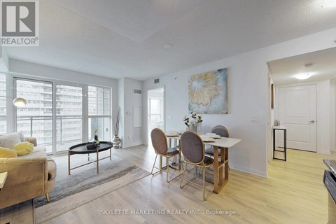 A living room with a dining table and chairs.