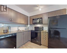 A modern kitchen with wooden cabinets and stainless steel appliances.