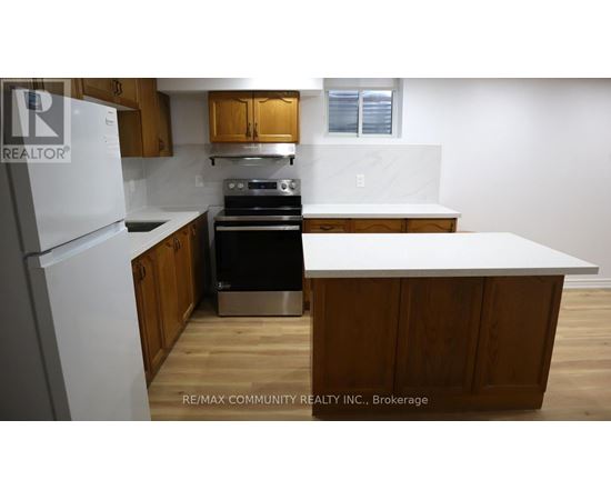 A kitchen with wooden cabinets and a white refrigerator.