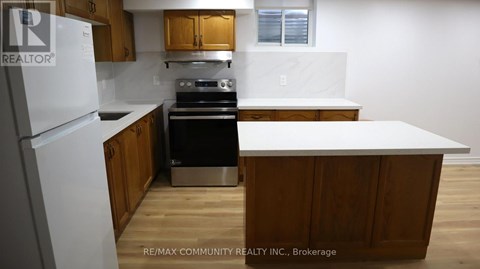 A kitchen with wooden cabinets and a white refrigerator.