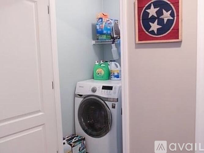 A white washing machine is in a small space.