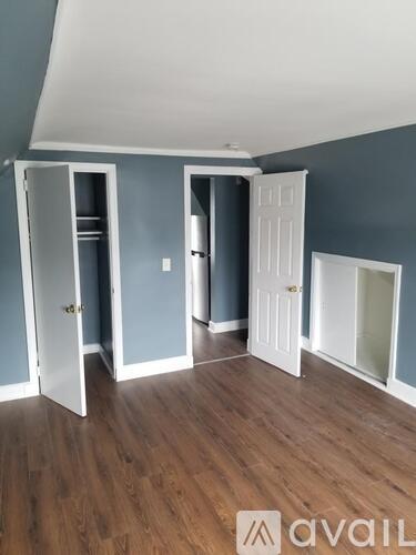 A room with a white door and a white cabinet in the corner.