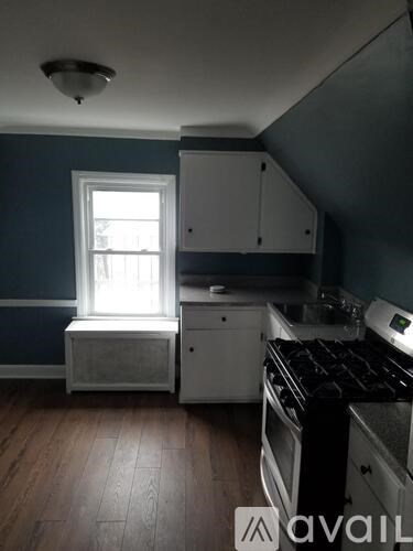 A kitchen with a stove and a window.