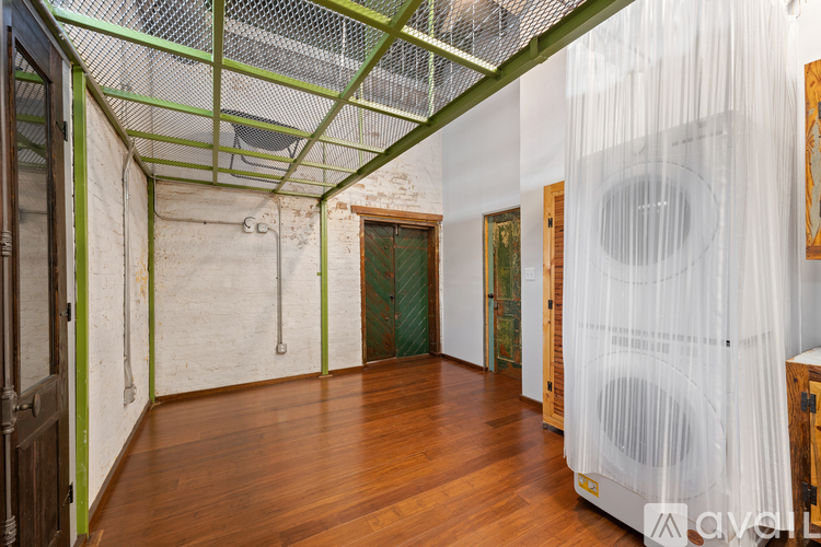 A room with wooden floors and a green and white striped ceiling.
