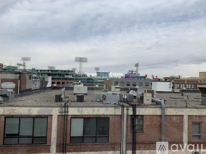 A view of a cityscape with a cloudy sky above.