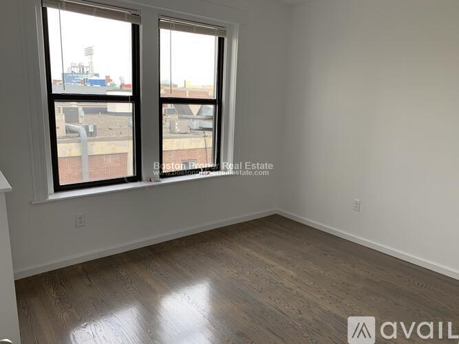 A room with a large window overlooking a cityscape.