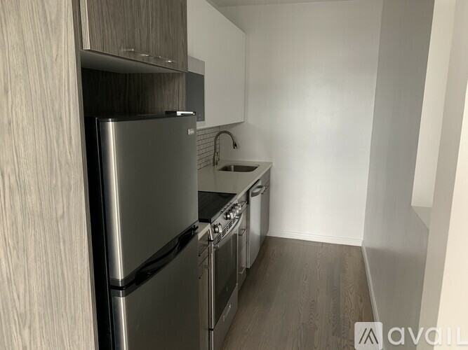 A modern kitchen with stainless steel appliances and wooden cabinets.