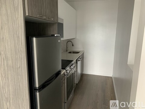 A modern kitchen with stainless steel appliances and wooden cabinets.