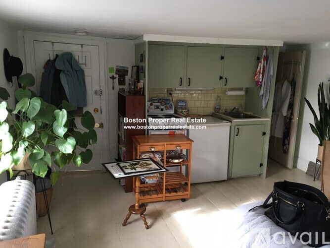A kitchen area with a table and chairs in the middle of the room.
