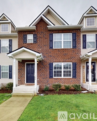 A house with a blue door and white windows.
