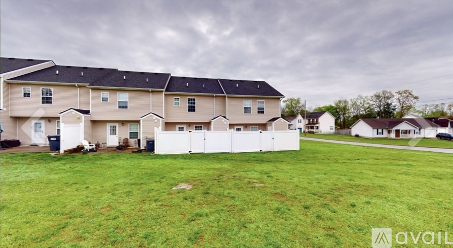 A row of houses with a grassy front yard.