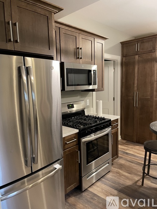 A kitchen with a stainless steel refrigerator and microwave.