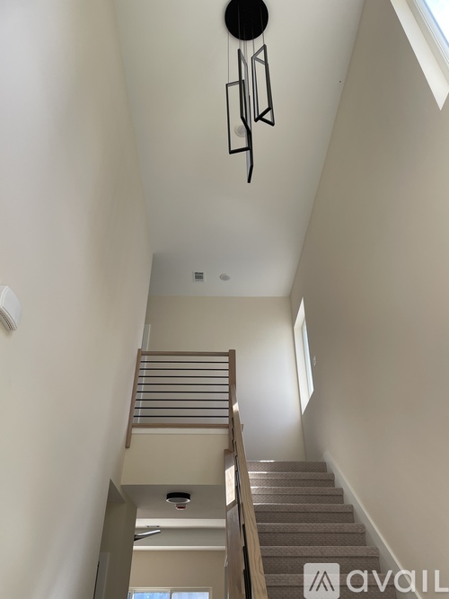 A bedroom with a bed, chair, and a ceiling fan.