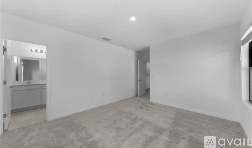 A spacious, empty room with a Lexus sign on the door.