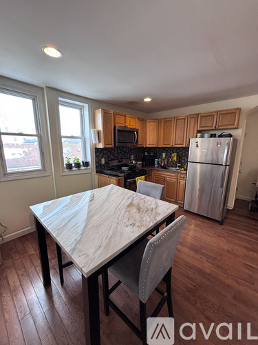A kitchen with a table and chairs in the foreground.