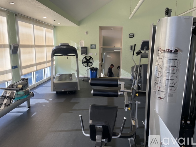 A gym with treadmills, exercise bikes, and other equipment.