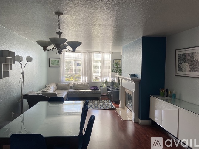 A dining room with a glass table and chairs.