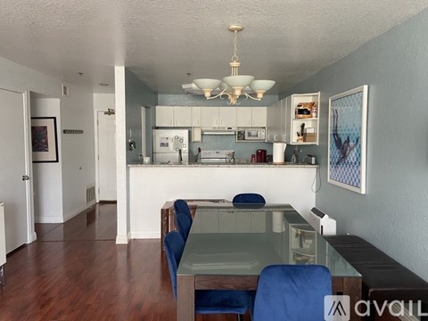 A kitchen with a dining table and chairs.