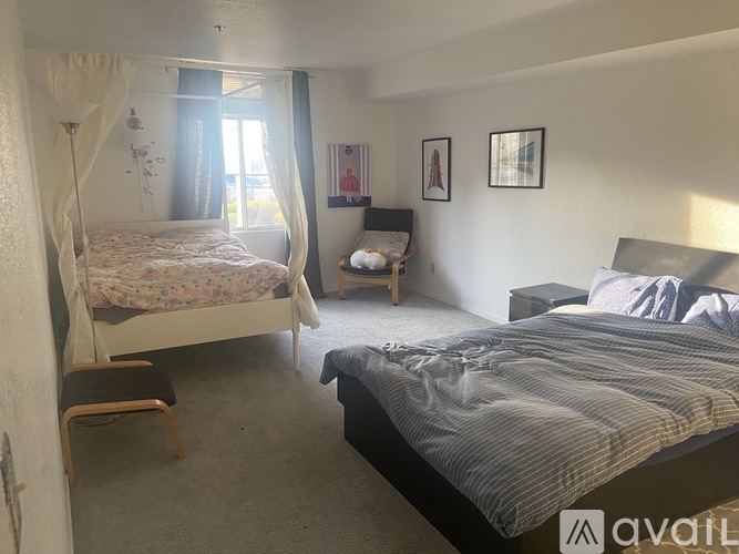 A bedroom with a canopy bed and a single bed.
