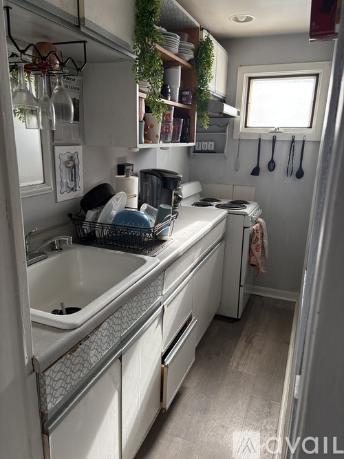 A kitchen with a sink and a window.