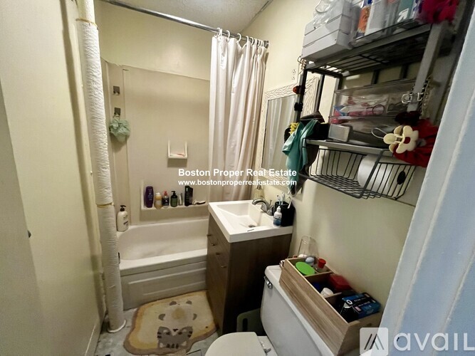 A small bathroom with a toilet, sink, and bathtub.