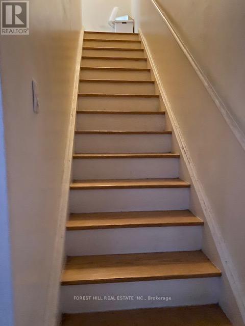 A staircase with wooden steps and white walls.