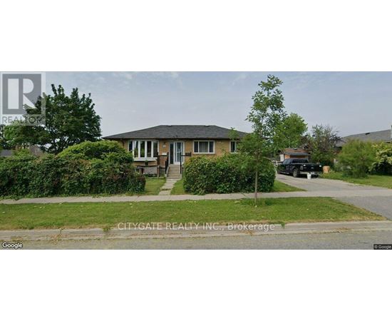 A house with a front yard and a tree in front of it.