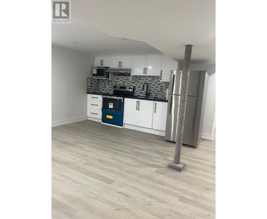 A kitchen with white cabinets and a blue drawer.