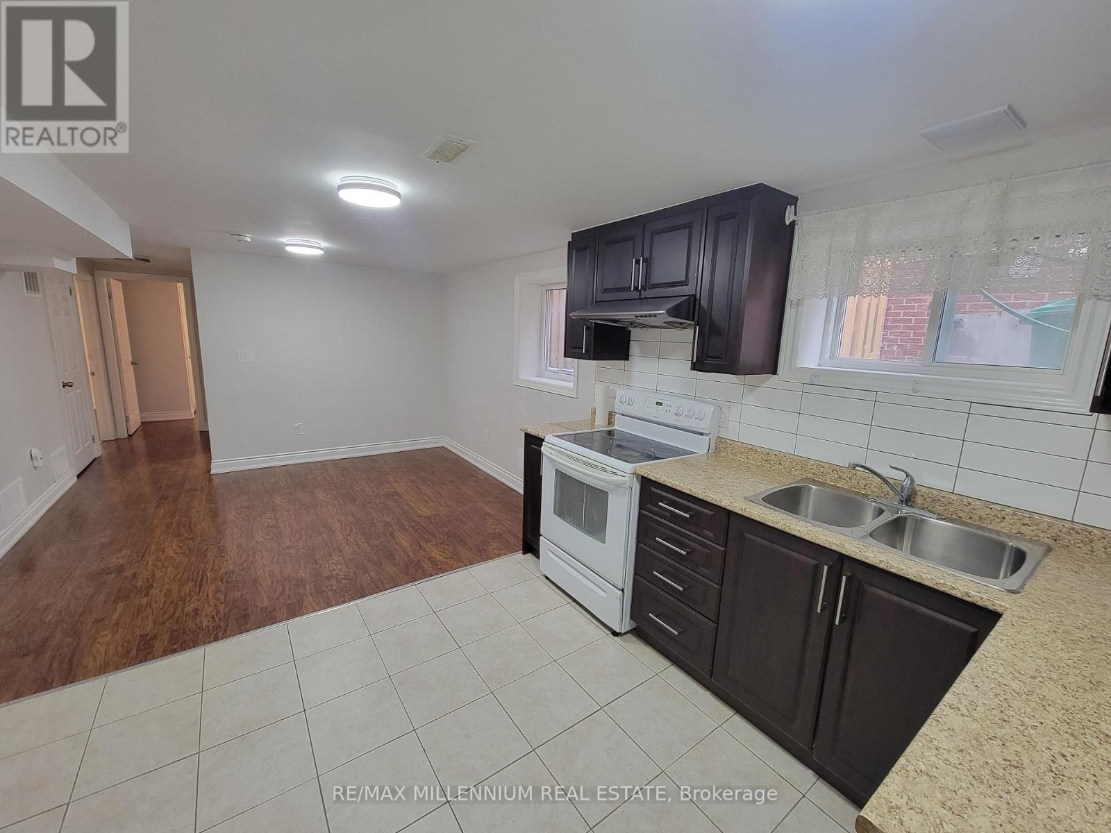 A kitchen with a white oven and black cabinets.