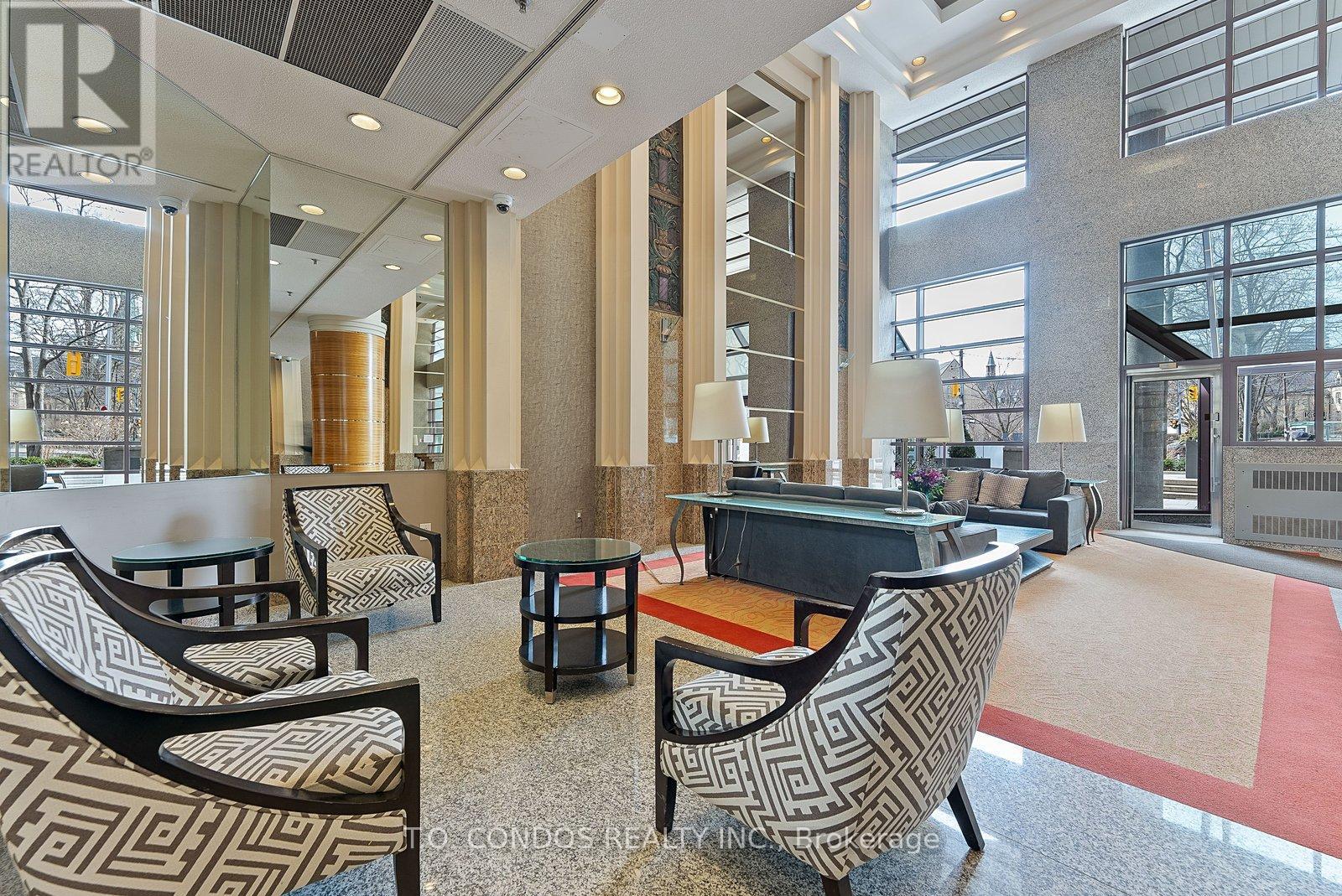 A large, modern lounge area with patterned chairs and a piano.