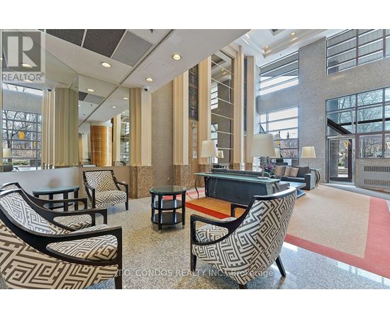 A large, modern lounge area with patterned chairs and a piano.