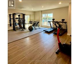 A spacious home gym with a variety of exercise equipment.