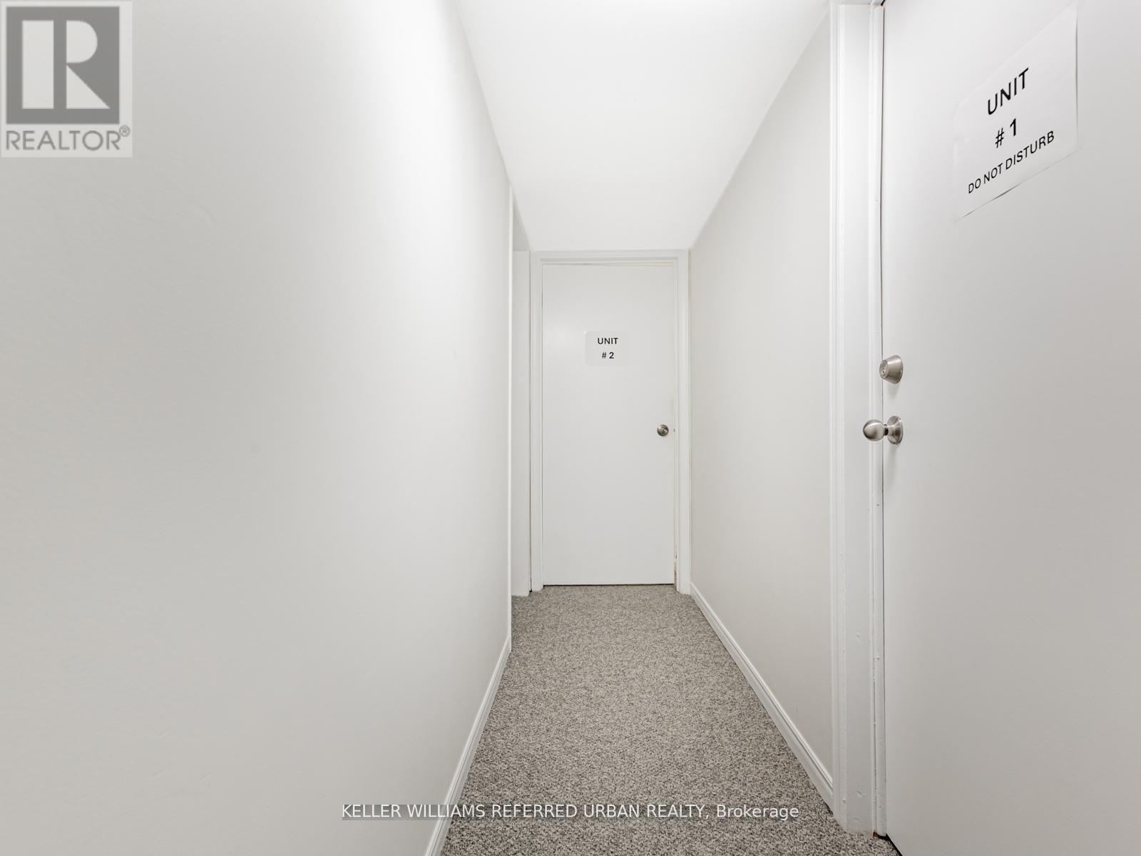 A hallway with a sign that says "Unit #1 Do Not Disturb".