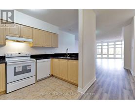 A kitchen with white appliances and wooden cabinets.