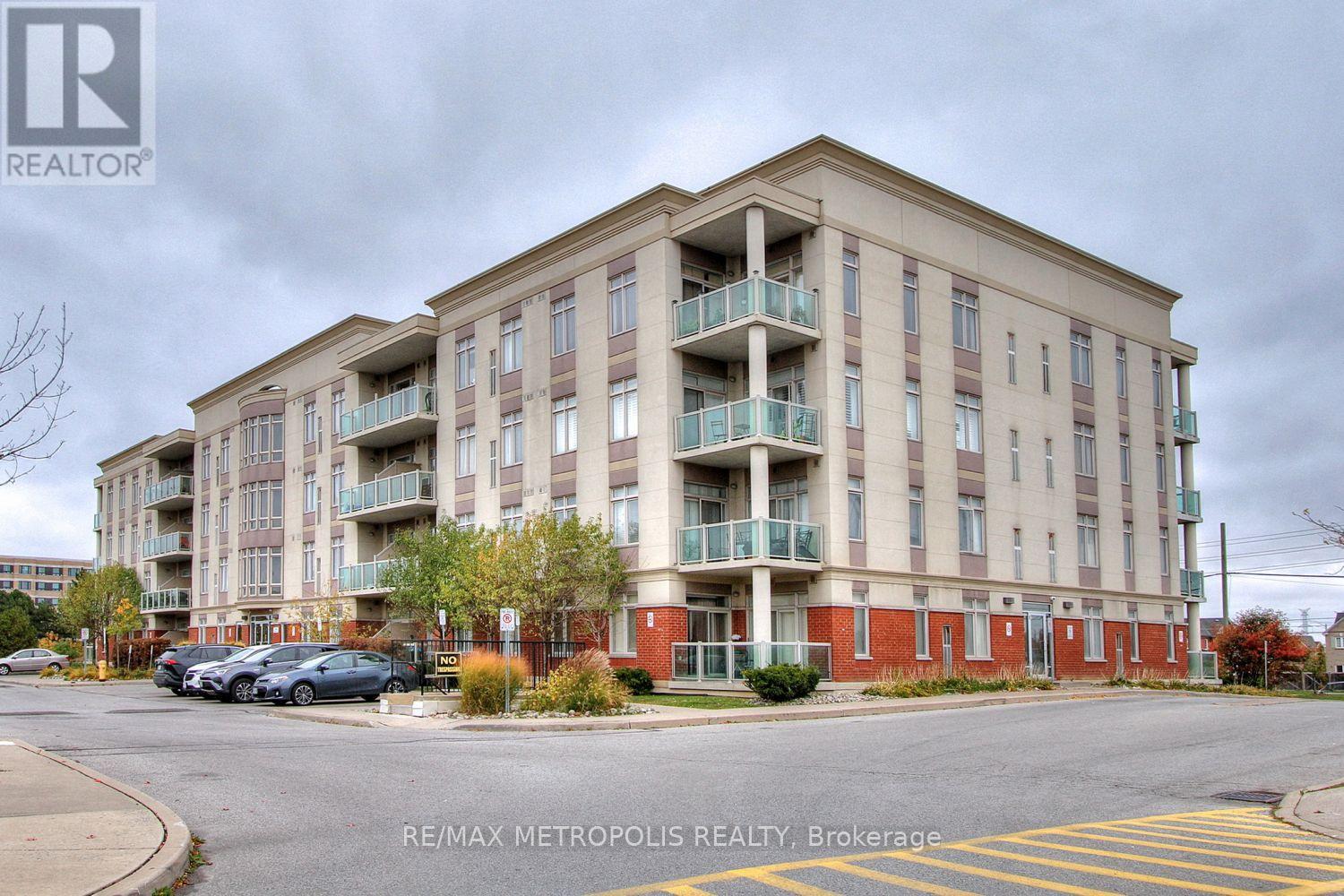 A large apartment building with a parking lot in front.