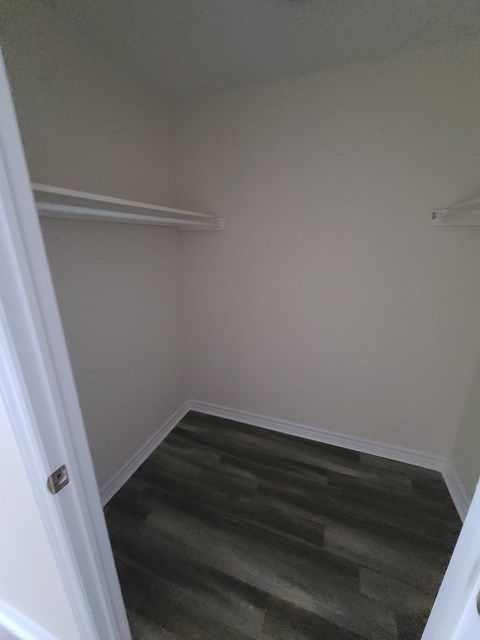A room with a carpeted floor and a white door.
