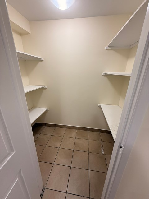 Empty white shelves in a room.