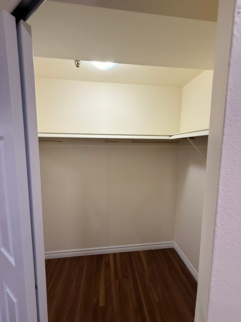 A white door is open to a room with a light on the ceiling.