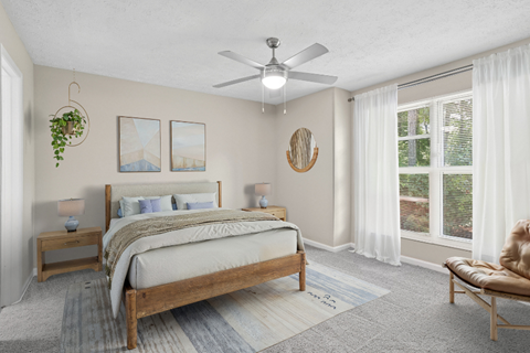 A bedroom with a large bed and a ceiling fan.
