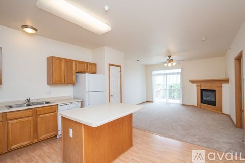 A kitchen with wooden cabinets and a white countertop.