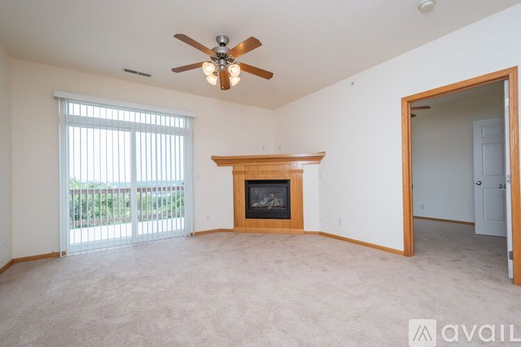 A living room with a fireplace and sliding glass doors.