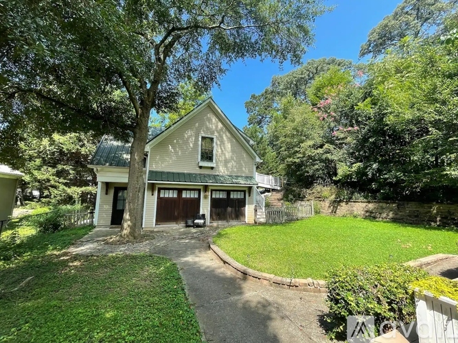 A house with a green lawn and trees around it.