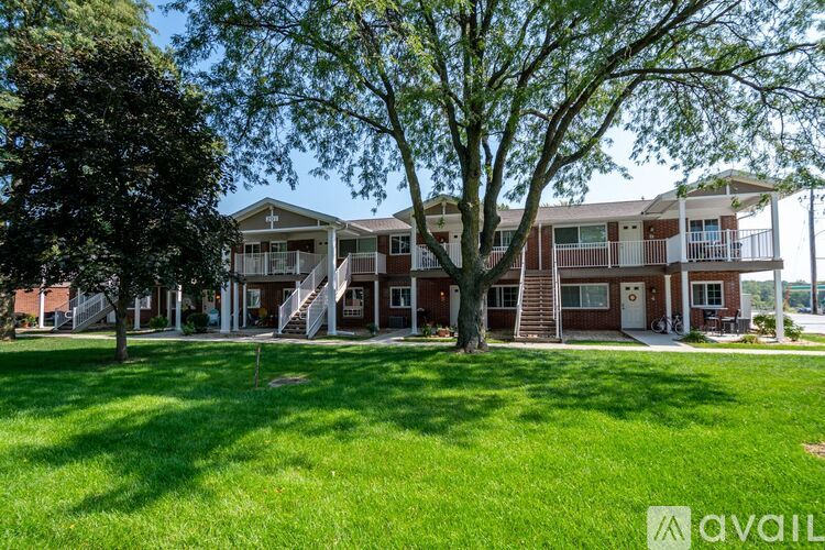 A large grassy area in front of apartment buildings.