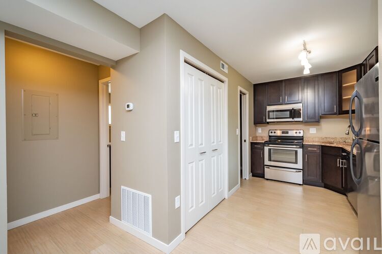 A kitchen with a refrigerator, oven, and microwave.