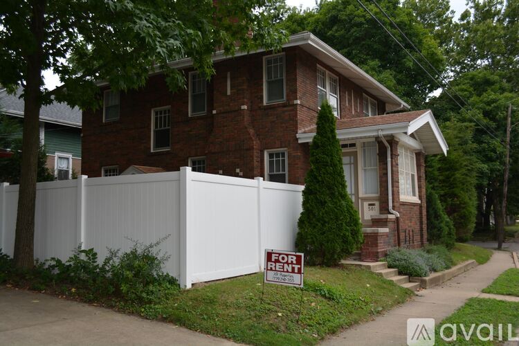 A house with a for rent sign in front of it.