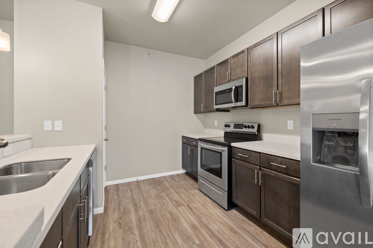 A kitchen with wooden cabinets and stainless steel appliances.